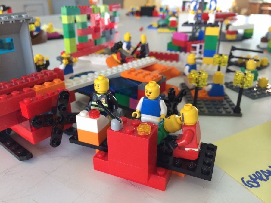 Lego figures building an office