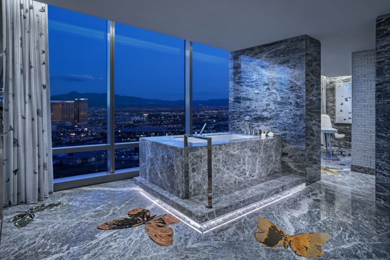 inlaid butterflies add visual interest to the vast slabs of gray marble an adjoining massage room makes for the ultimate spa like bathroom