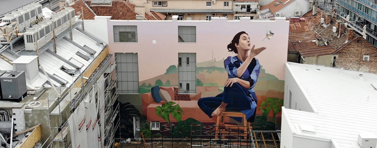Woman with sparrow, part of Artez's latest mural